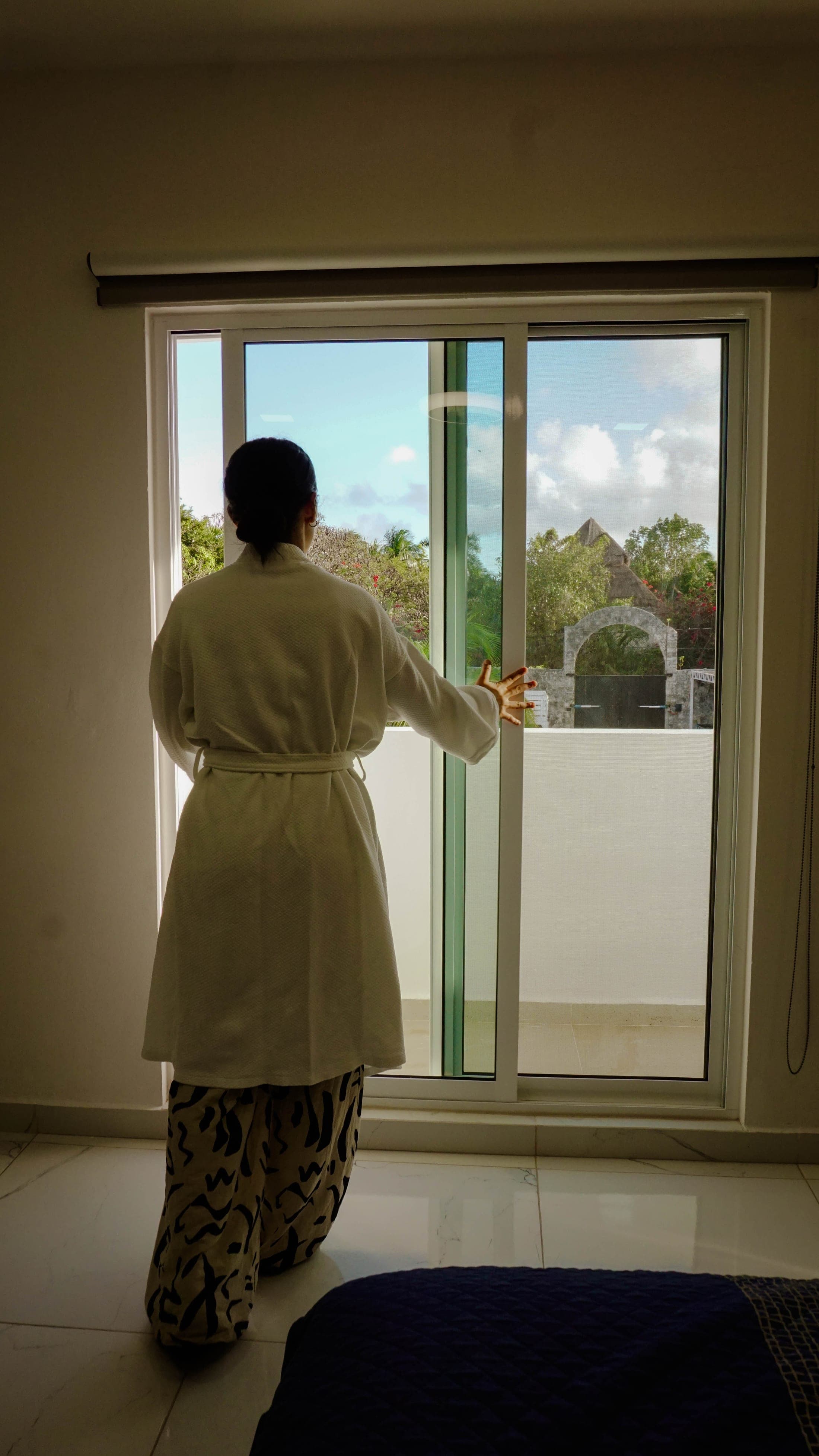 A guest gazing at the garden from the room