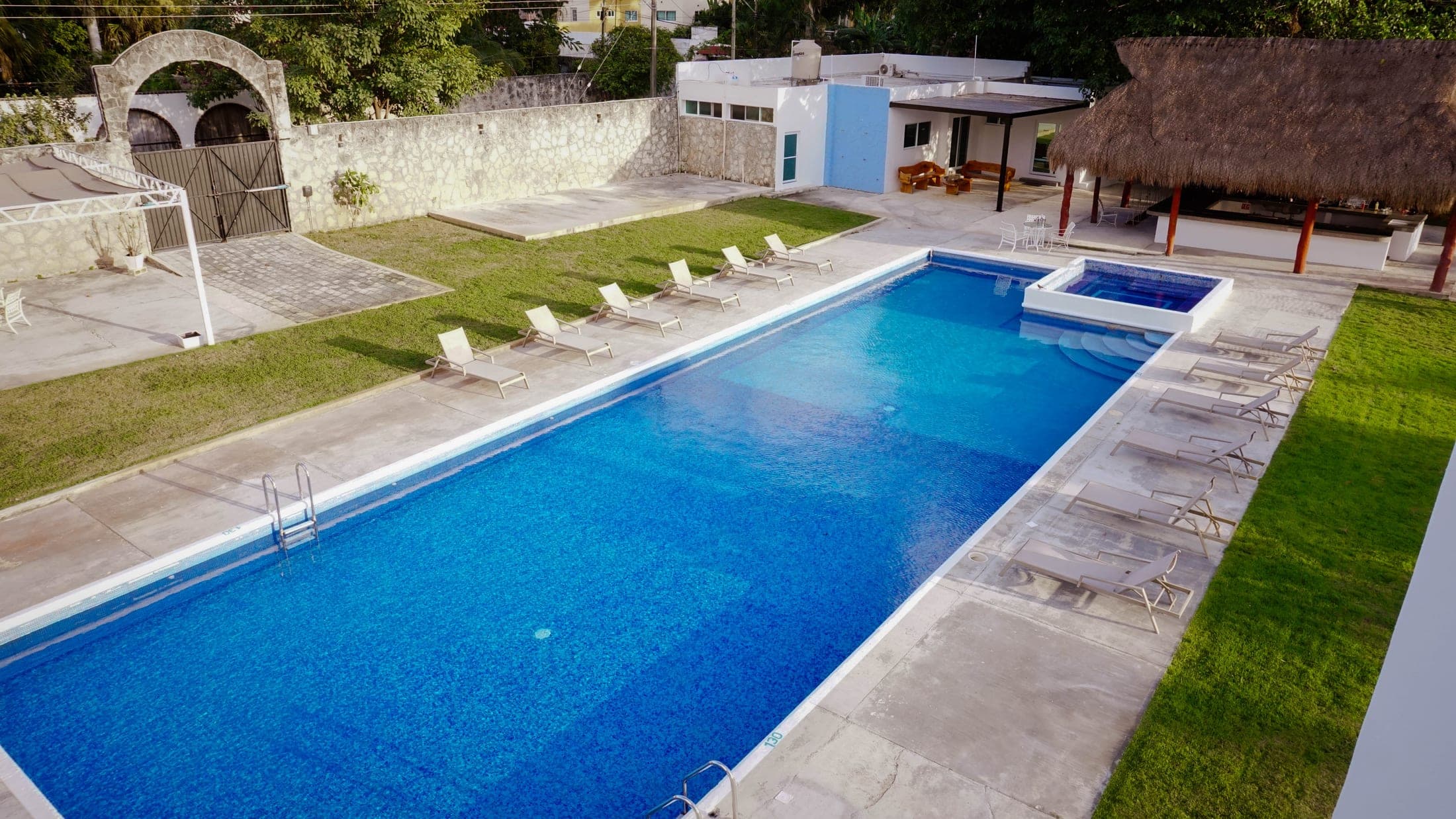 Sun loungers and palapa around the pool